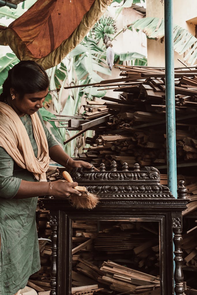 Artisan applying a hand finish to a custom wood piece in the Zarapie workshop.