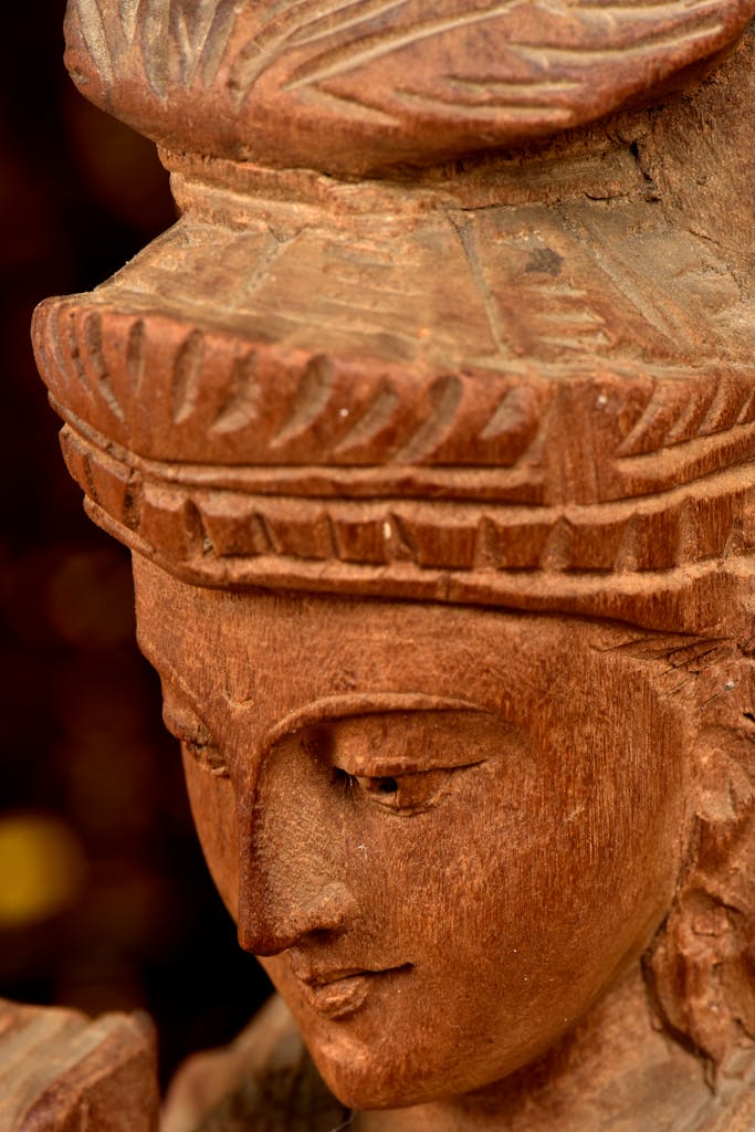 Detailed close-up of a traditional Indian wooden sculpture, showcasing intricate craftsmanship.